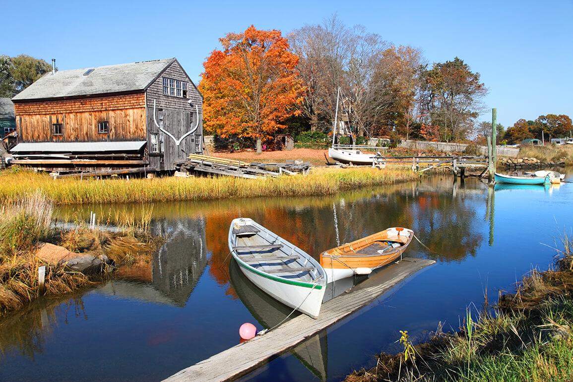 Two small boats tied to a dock on a river