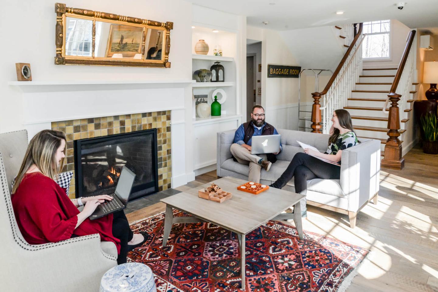 Three people working in an inn lobby