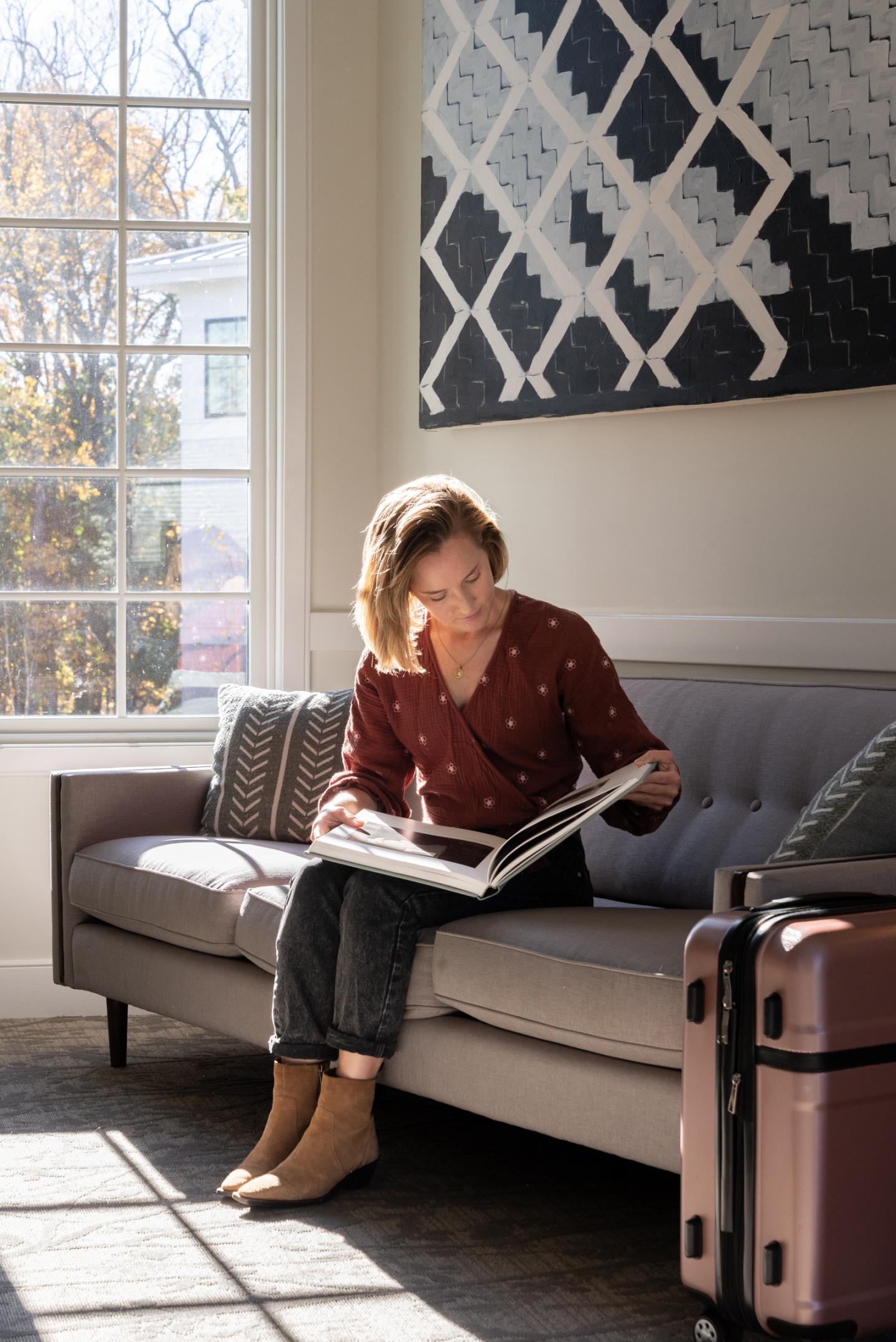 A person reading on a couch