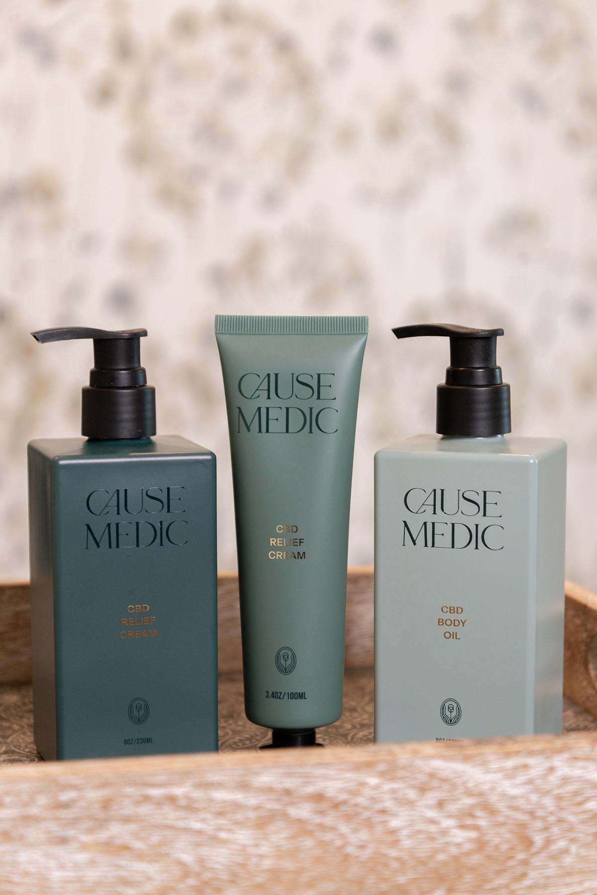 Luxury skincare bottles and tube on wooden tray.