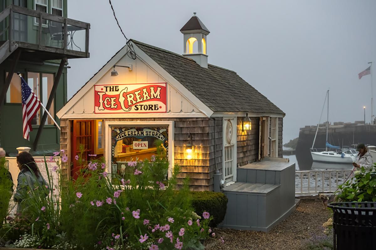 Foggy harbor scene with a small, welcoming ice cream shop.