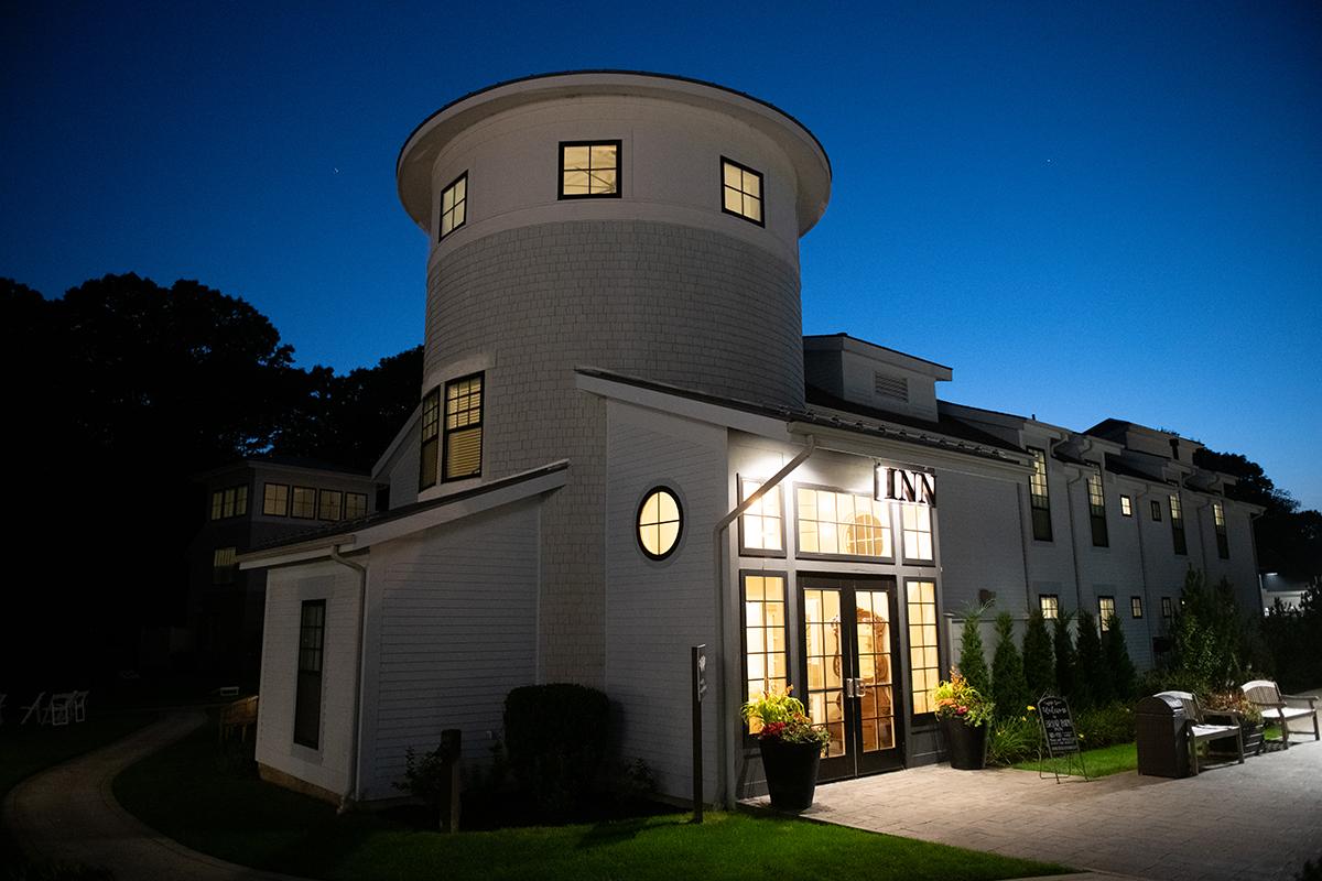 Modern building with lit windows at dusk.