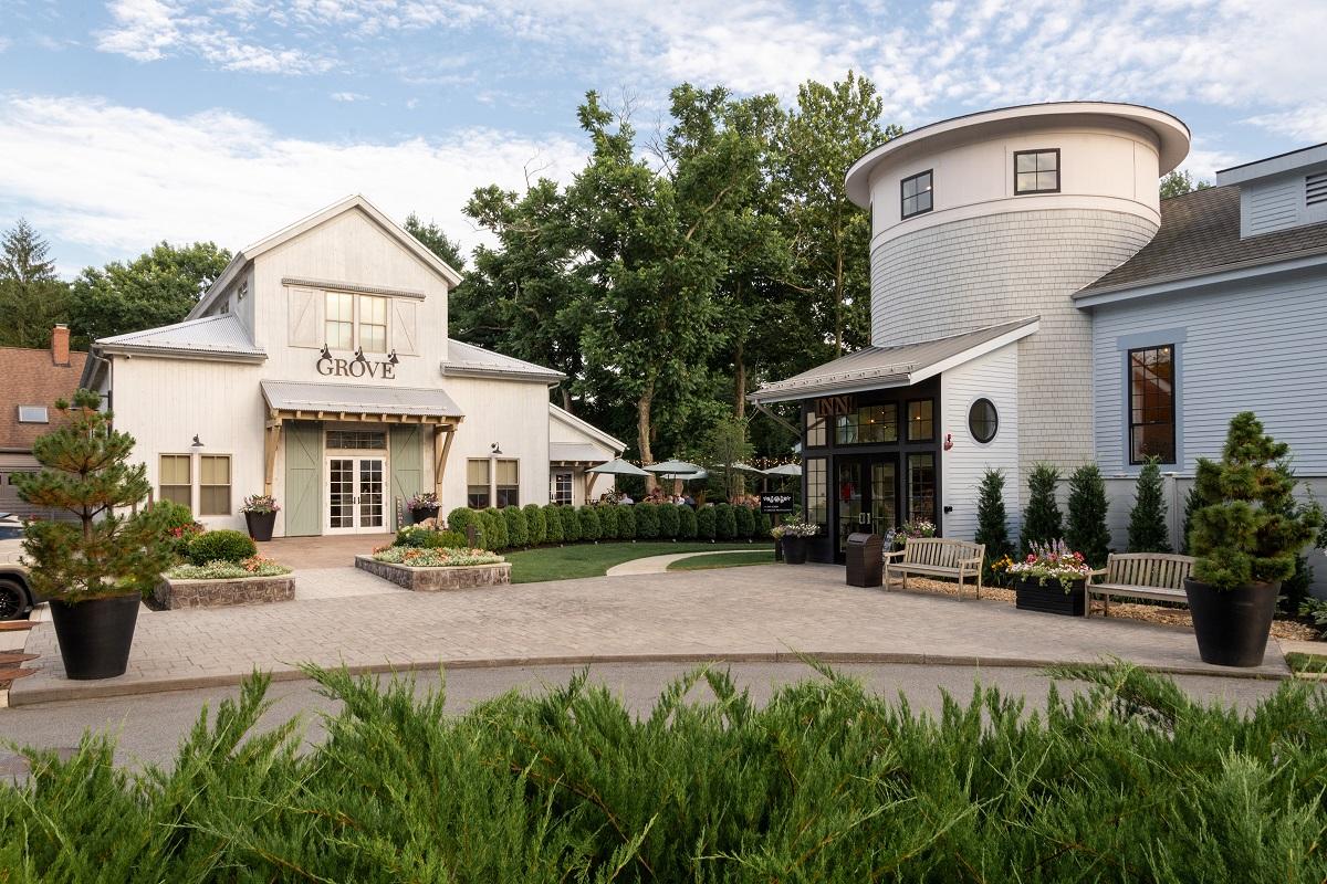 Charming building with white walls and circular tower, surrounded by greenery.