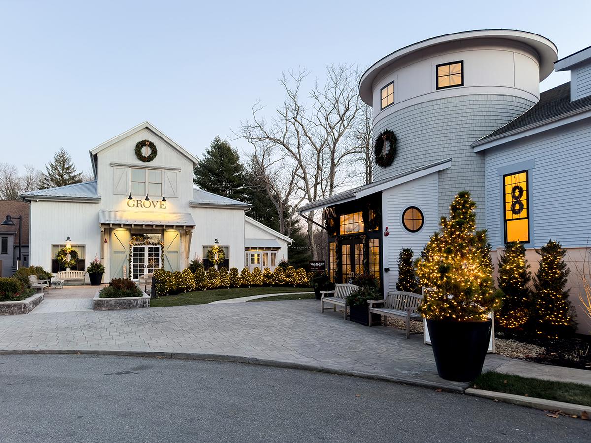 Elegant buildings with festive lights and wreaths in the evening.