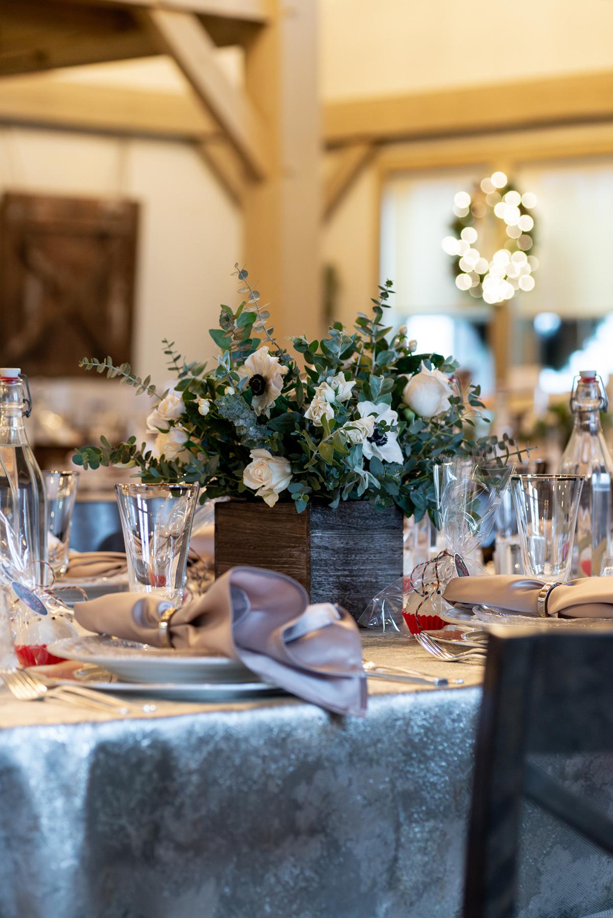 Elegant table setting with floral centerpieces and crystal glasses.